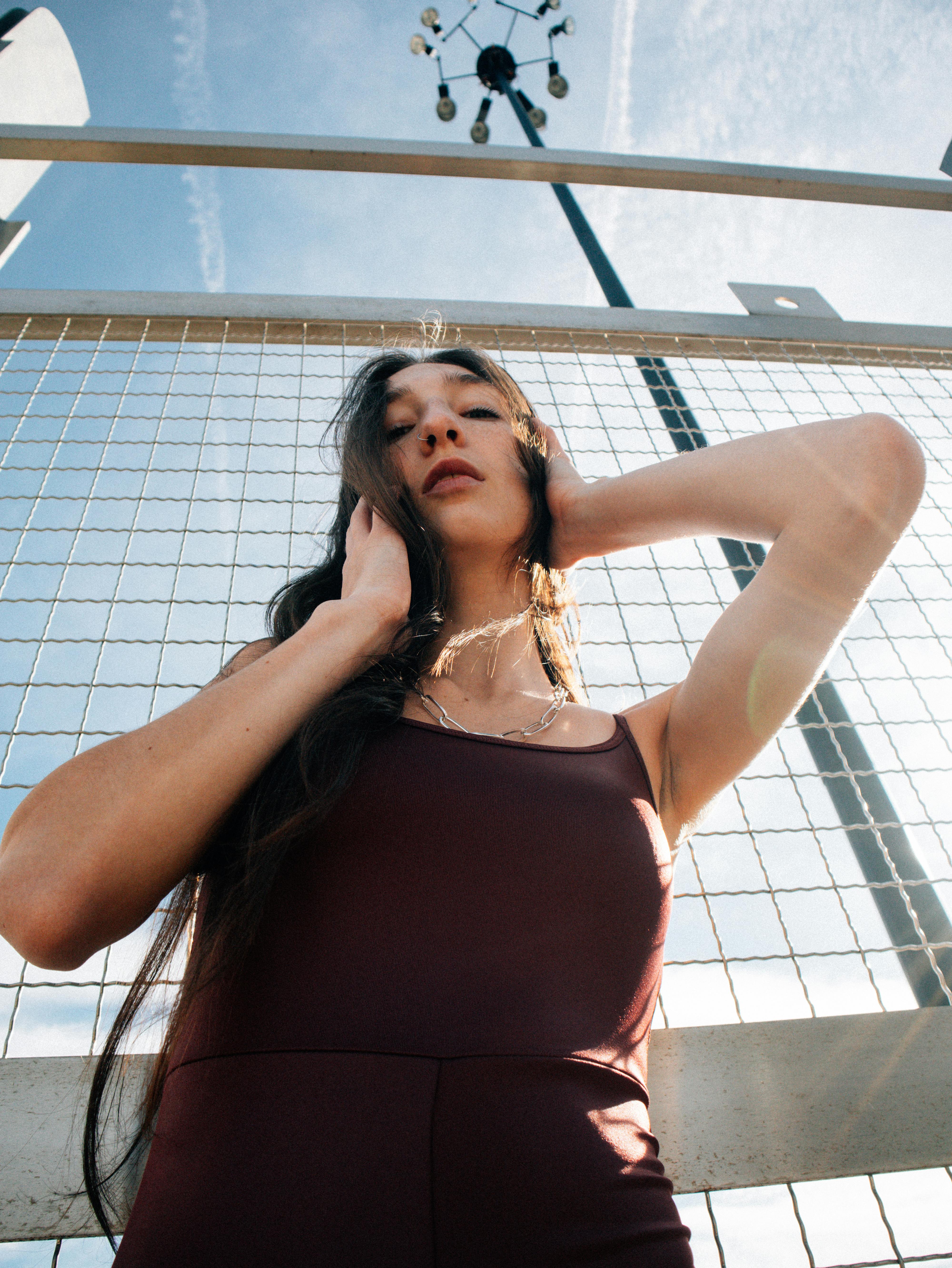 a woman in a red dress is posing for a photo