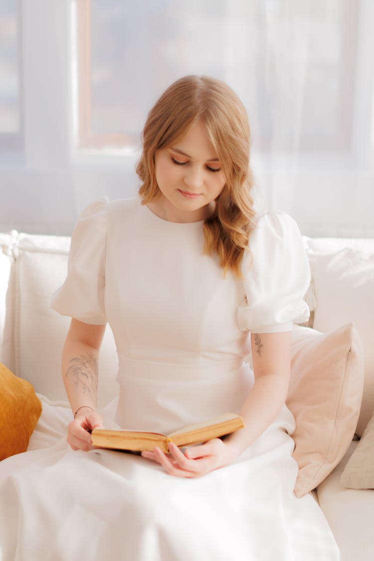 Young Woman In A White Dress Reading A Book 