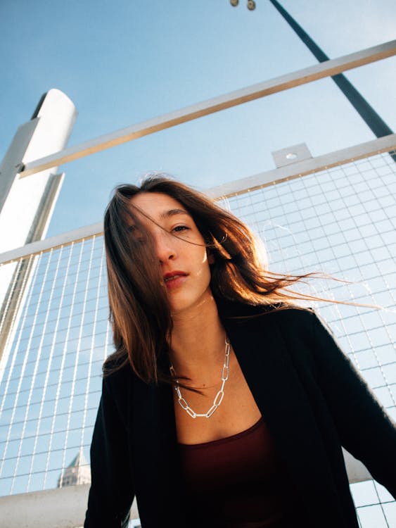 A woman with a necklace and a black jacket