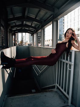 Stylish woman in burgundy outfit poses in a downtown Atlanta walkway.