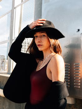 Fashion portrait of a woman in a black hat and blazer posing in Atlanta, showcasing urban style.