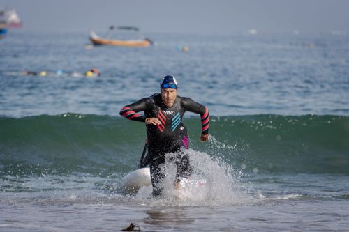 Free Dynamic shot of an athlete emerging from the sea during a triathlon, showcasing endurance and determination. Stock Photo