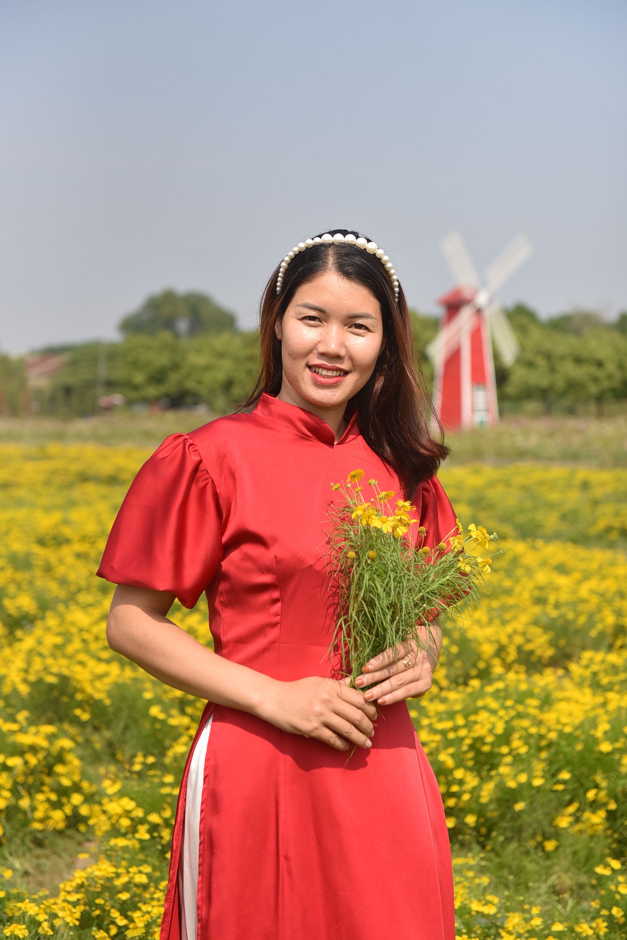 Young Woman in a Dress Standing Outside and Holding Flowers · Free ...
