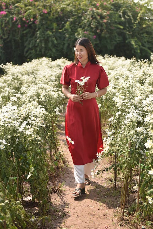 Smiling Woman in Red Clothes among Flowers