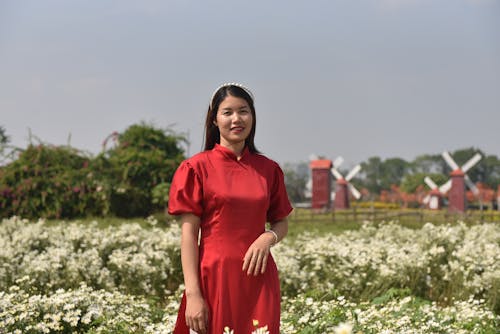 Smiling Woman in Red Dress on Meadow