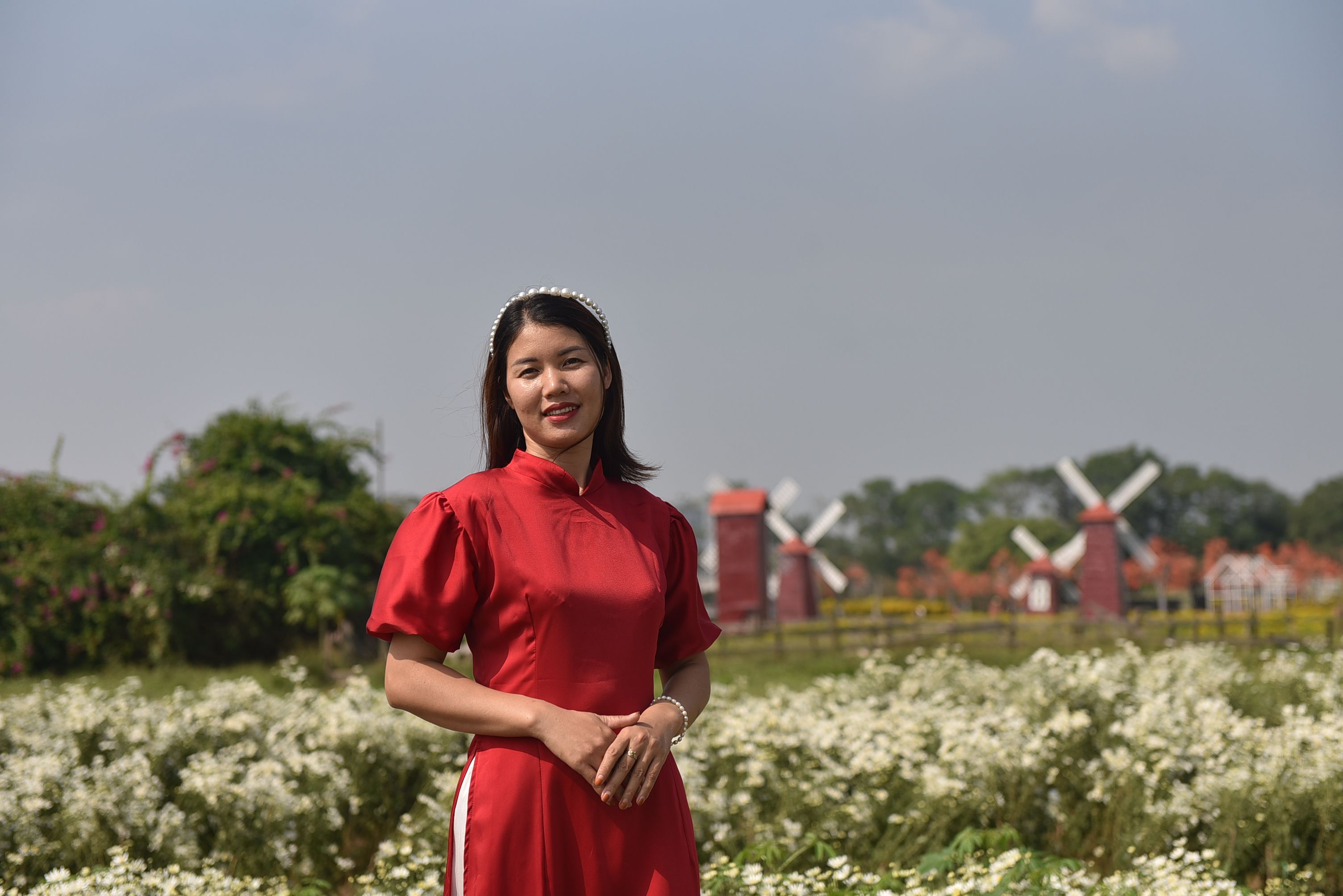 Brunette Woman in Red Dress Posing in Flower Field · Free Stock Photo