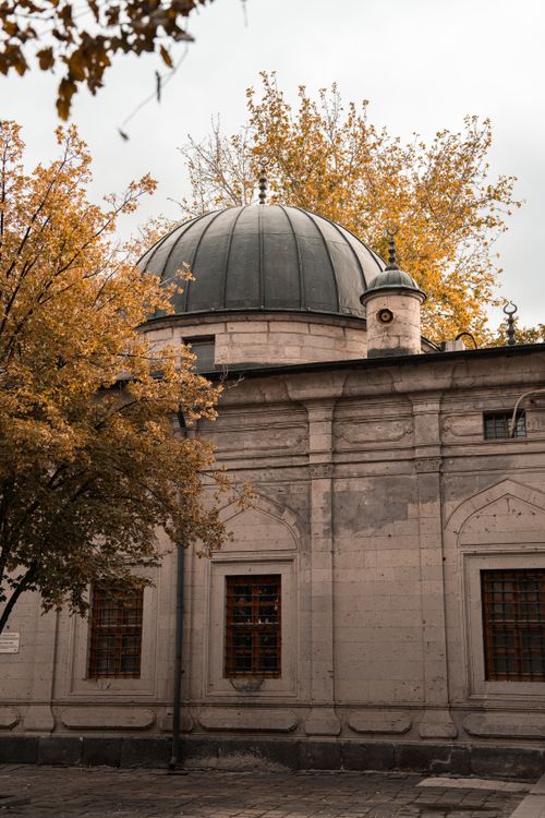 Free Beautiful autumn scene featuring the facade and dome of a historic mosque in Kayseri, Turkey. Stock Photo