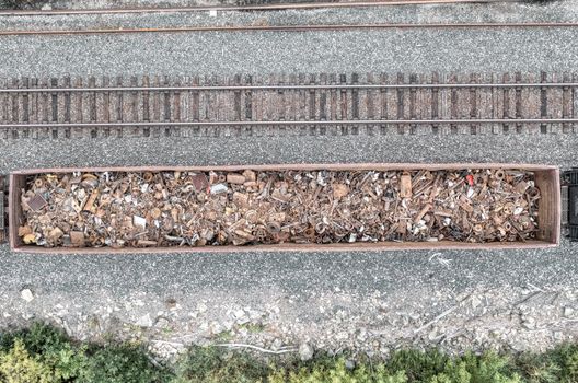 Top View of a Cargo Train Carriage Full of Rusty Metal Elements 