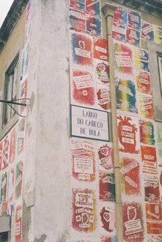 Vibrant street art decorates a building corner in Lisbon, Portugal.