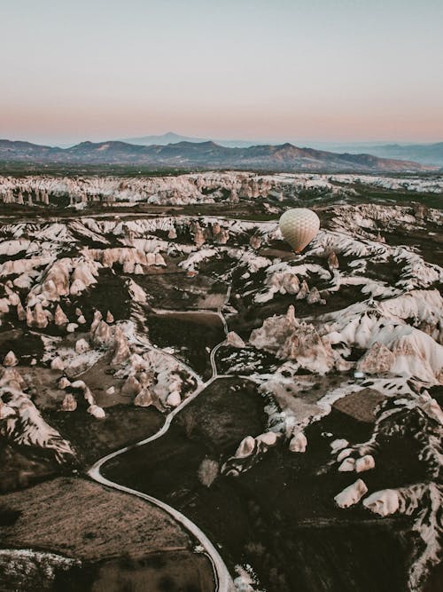 Aerial View of a Hot Air Balloon Flying over Cappadocia, Turkey 