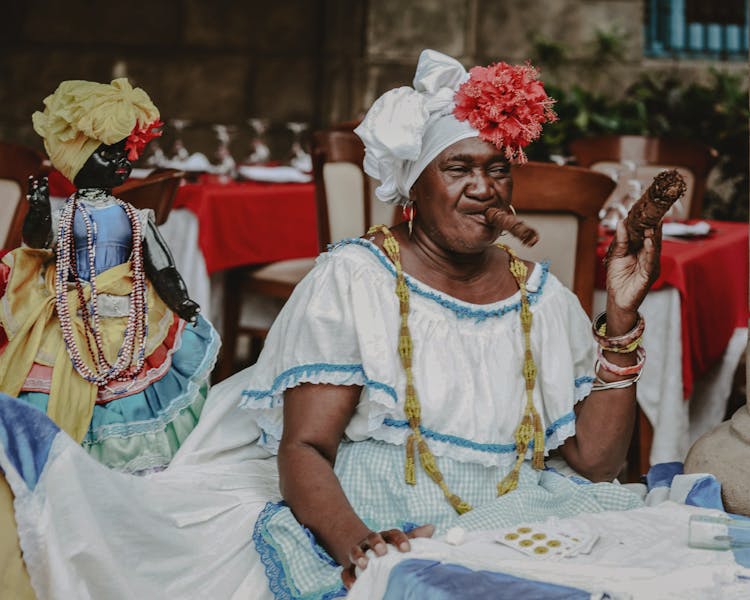 Havana Fortune Teller Sitting At A Restaurant Table Smoking Large Cigars