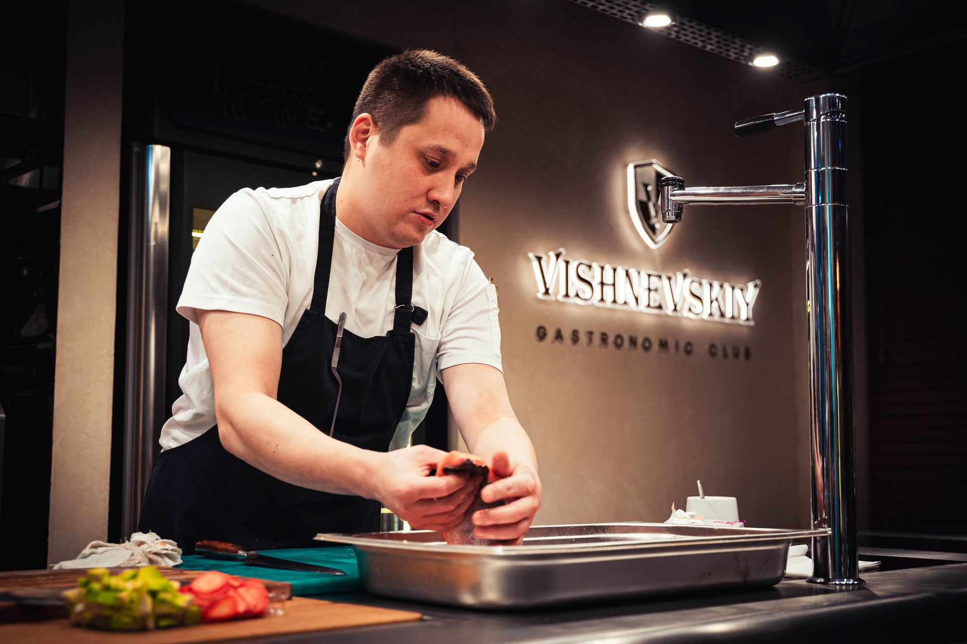 Chef plating a gourmet dish in a professional kitchen