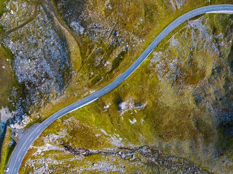 Aerial shot of a winding road through Hochtor mountain landscape in Austria.