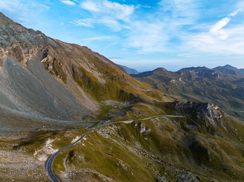 Free A winding road through scenic mountains under a clear blue sky. Stock Photo