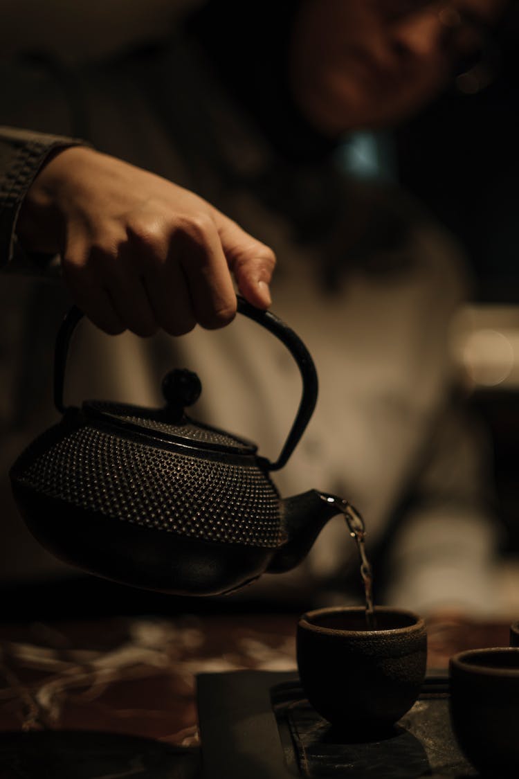 Woman Pouring Water From Kettle