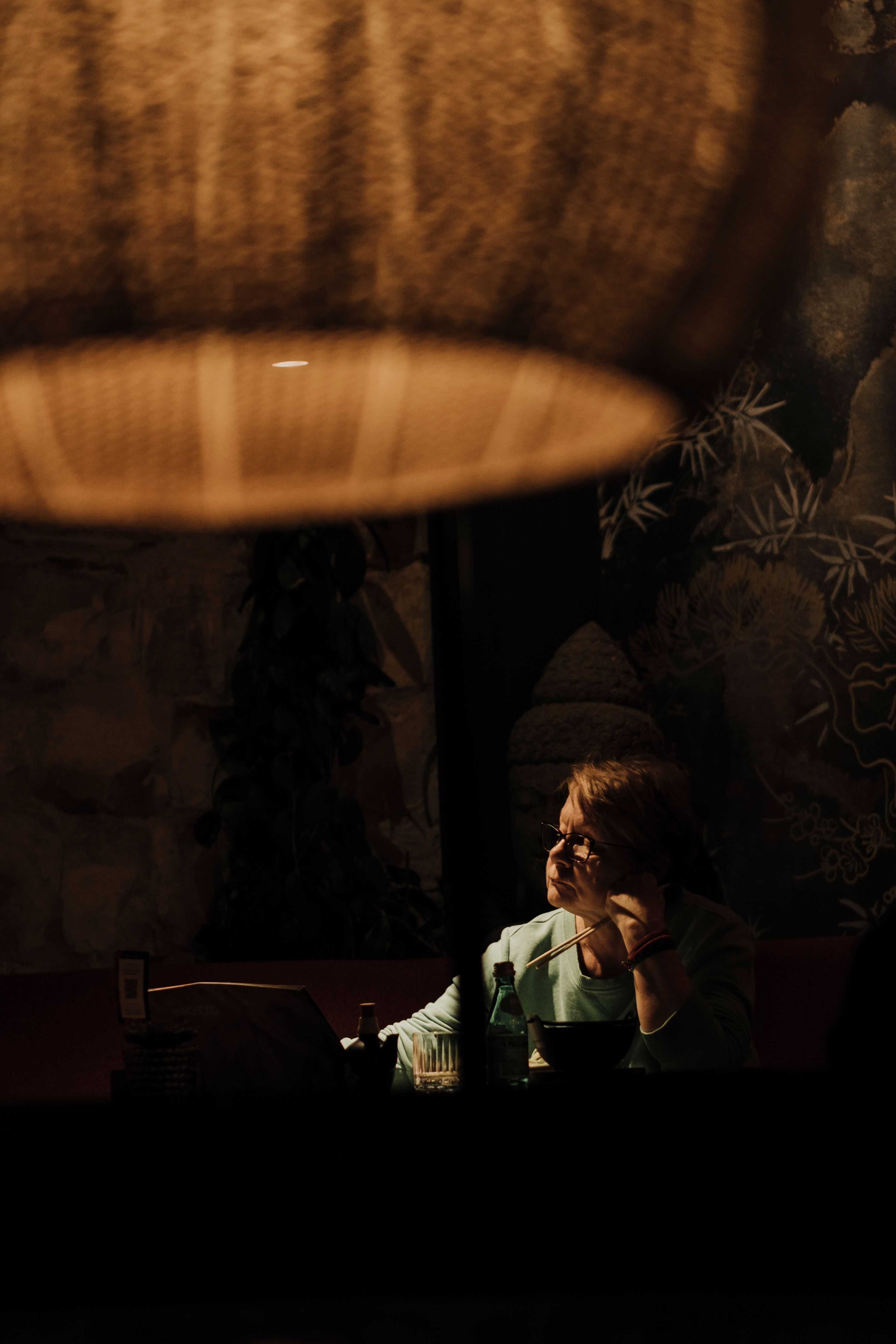 Woman Sitting in a Dark Room · Free Stock Photo