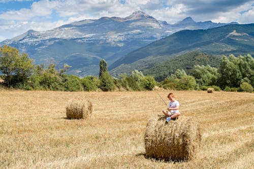 Boy Sitting on an Hay Bale 