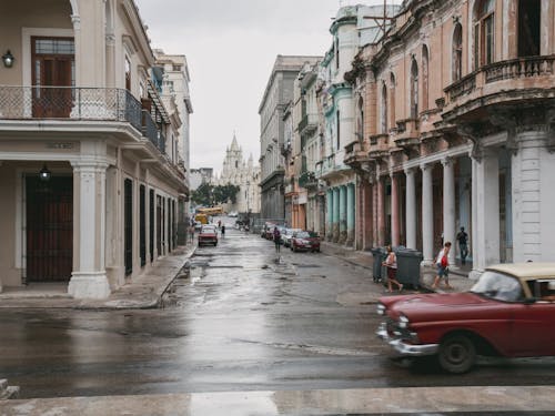 Alley with Colonial Buildings and Vintage Cars in a Cuban City 