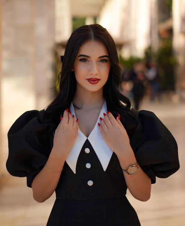 Beautiful Model in a Retro Black Dress with Puffy Sleeves and a Wide White Collar in the Hall of a Shopping Mall Free Stock Photo Beautiful Model in a Retro Black Dress with Puffy Sleeves and a Wide White Collar in the Hall of a Shopping Mall Free Stock Photo