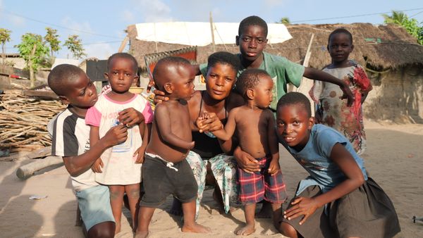 African children and woman in village community