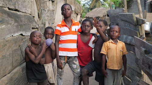 Photo of Group of Boys Posing in a Village