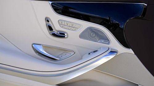 Free Close-up view of a luxury car door interior showcasing sleek design and technology. Stock Photo