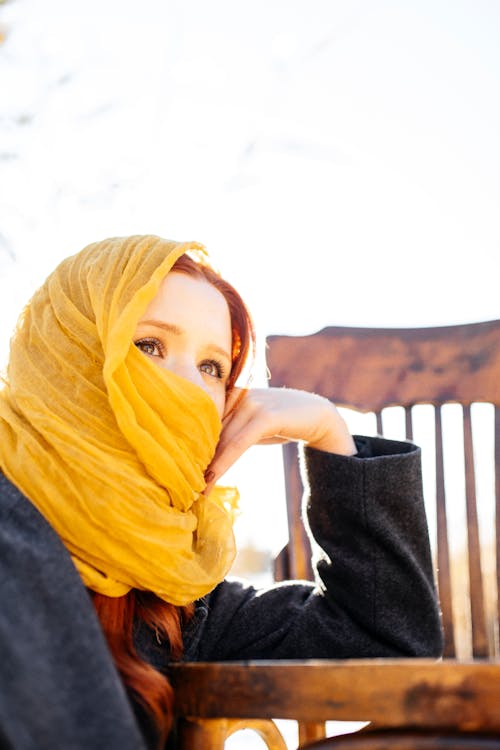 Redhead Woman Wearing a Yellow Headscarf, Leaning against a Chair