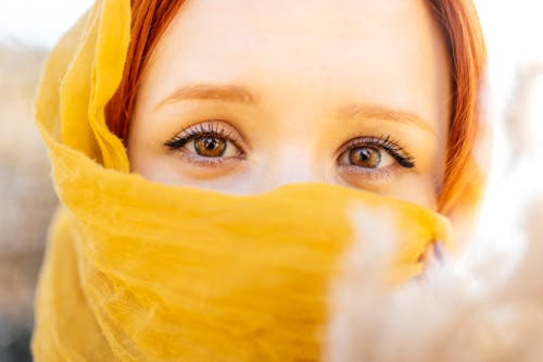 Redhead Model in Yellow Headscarf Covering Face