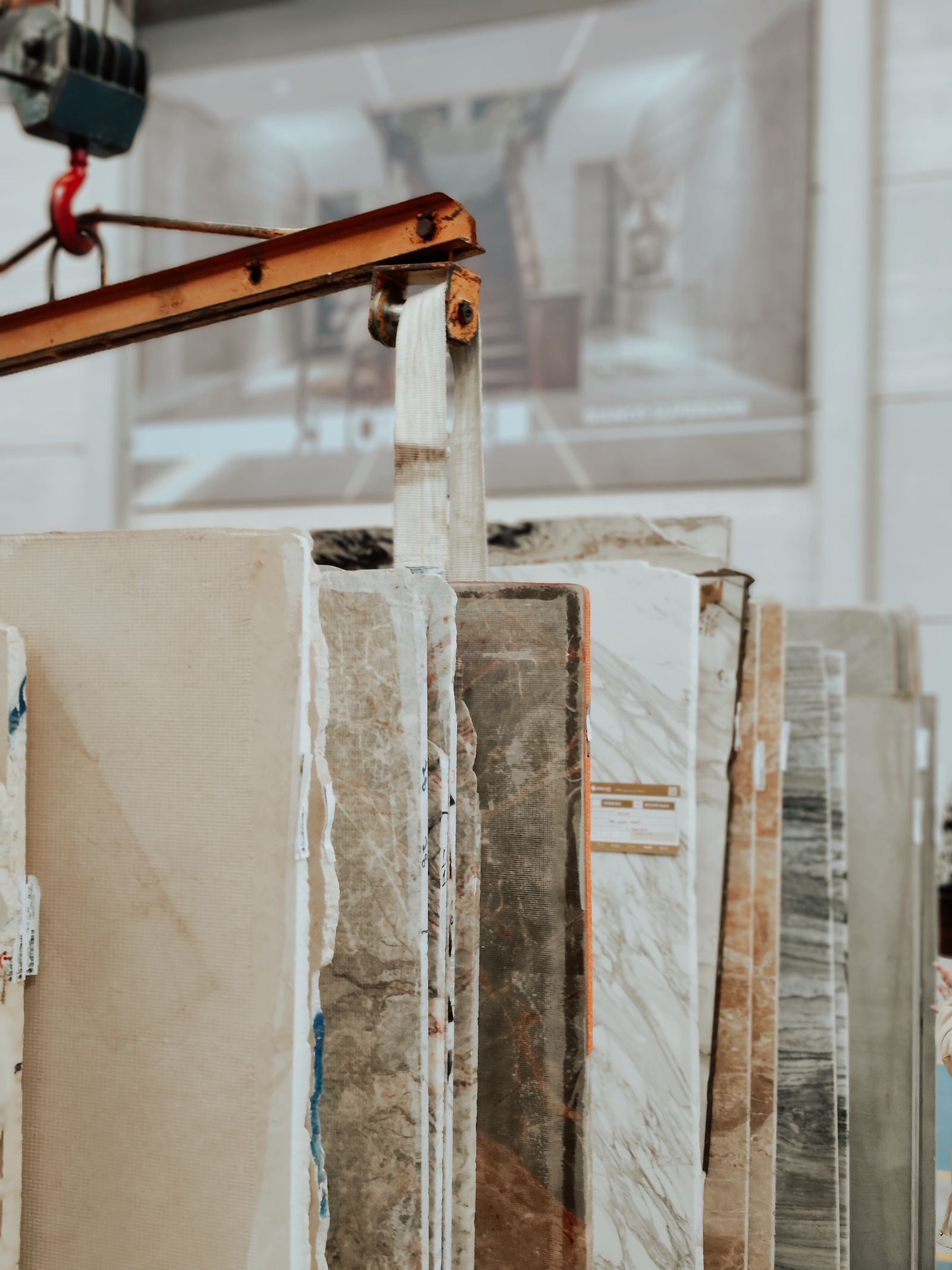 Marble and granite slabs being handled with a construction hook