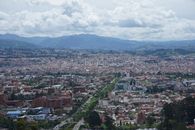 Stunning aerial view of Cuenca, Ecuador showcasing its dense urban landscape and mountainous backdrop.