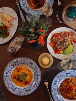 Elegant dining setup featuring gourmet dishes for a festive occasion, beautifully arranged on a decorated table.