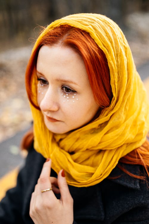 Young Woman Wearing a Yellow Scarf Standing Outside