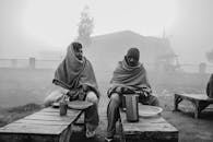 Men Sitting on Wooden Benches