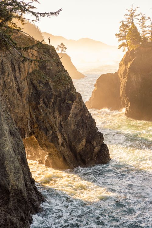 Free Majestic coastal cliffs with rays of sunlight illuminating the sea at sunrise. Stock Photo