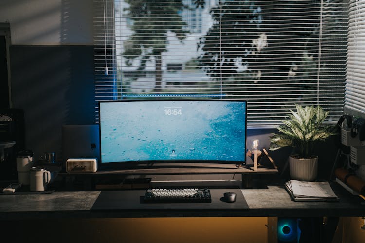 Home Working Space With A Computer Desk, And A Roller Blind On A Window