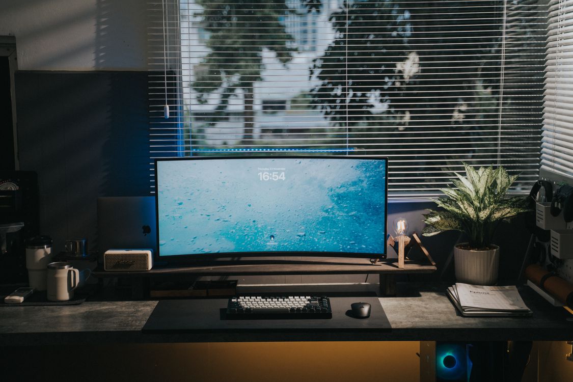 Using Pc Behind Window Home Working Space with a Computer Desk, and a Roller Blind on a Window ...