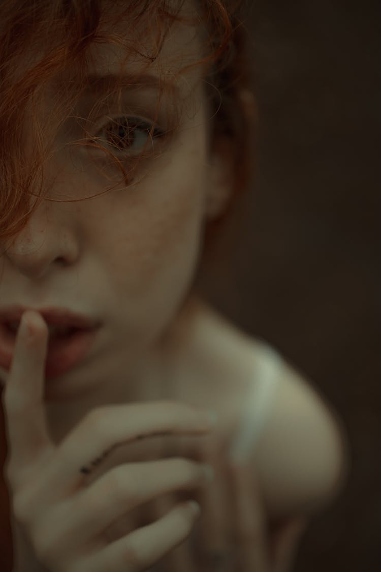 Tender Redhead Woman With Finger On Lips