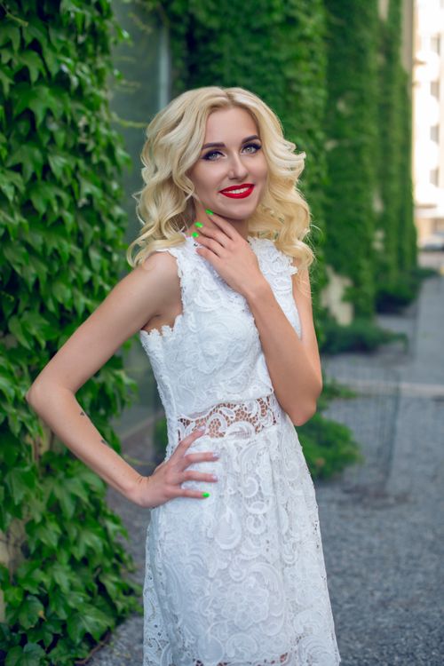 Free Stunning blonde bride in a lace dress smiling outdoors, captured in Sofia, Bulgaria. Stock Photo