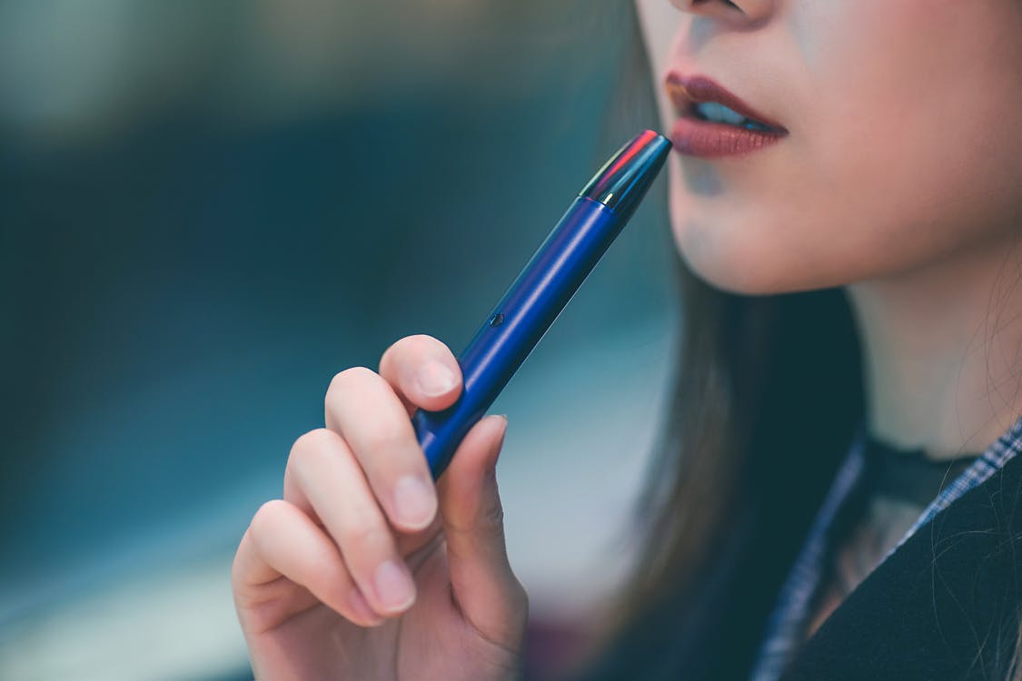 Woman Holding Blue Vape