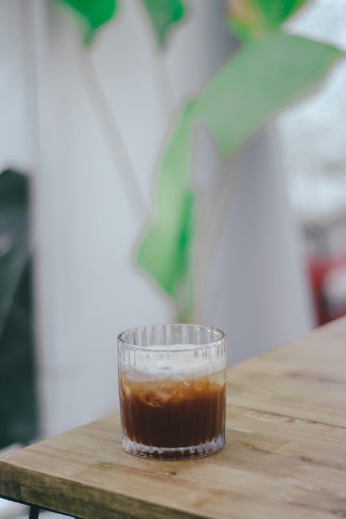 Free Close-up of a refreshing iced coffee with cream on a wooden table, perfect for a relaxing day. Stock Photo