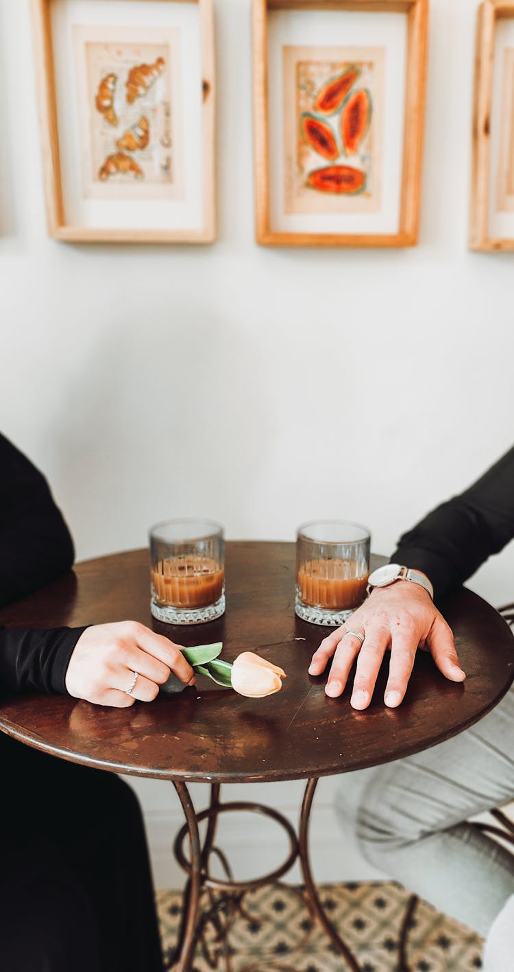 Hands Of Man And Woman At Cafe Table