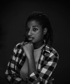 Striking black and white portrait of a woman posing in a studio.