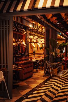 Charming urban restaurant interior with warm lighting and eclectic decor, perfect for dining and relaxation.