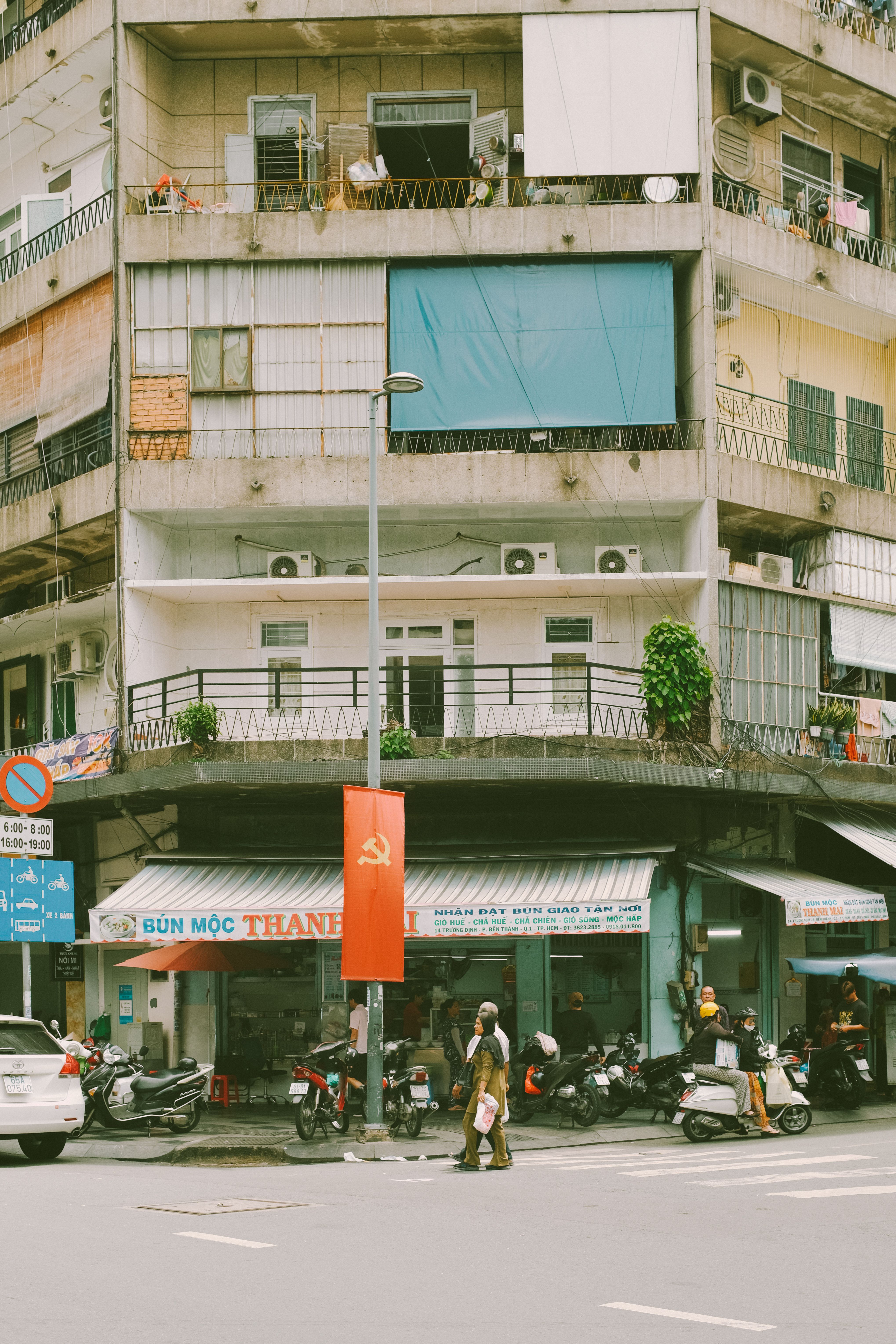 A vibrant street scene in a Vietnamese city with motorbikes and pedestrians.