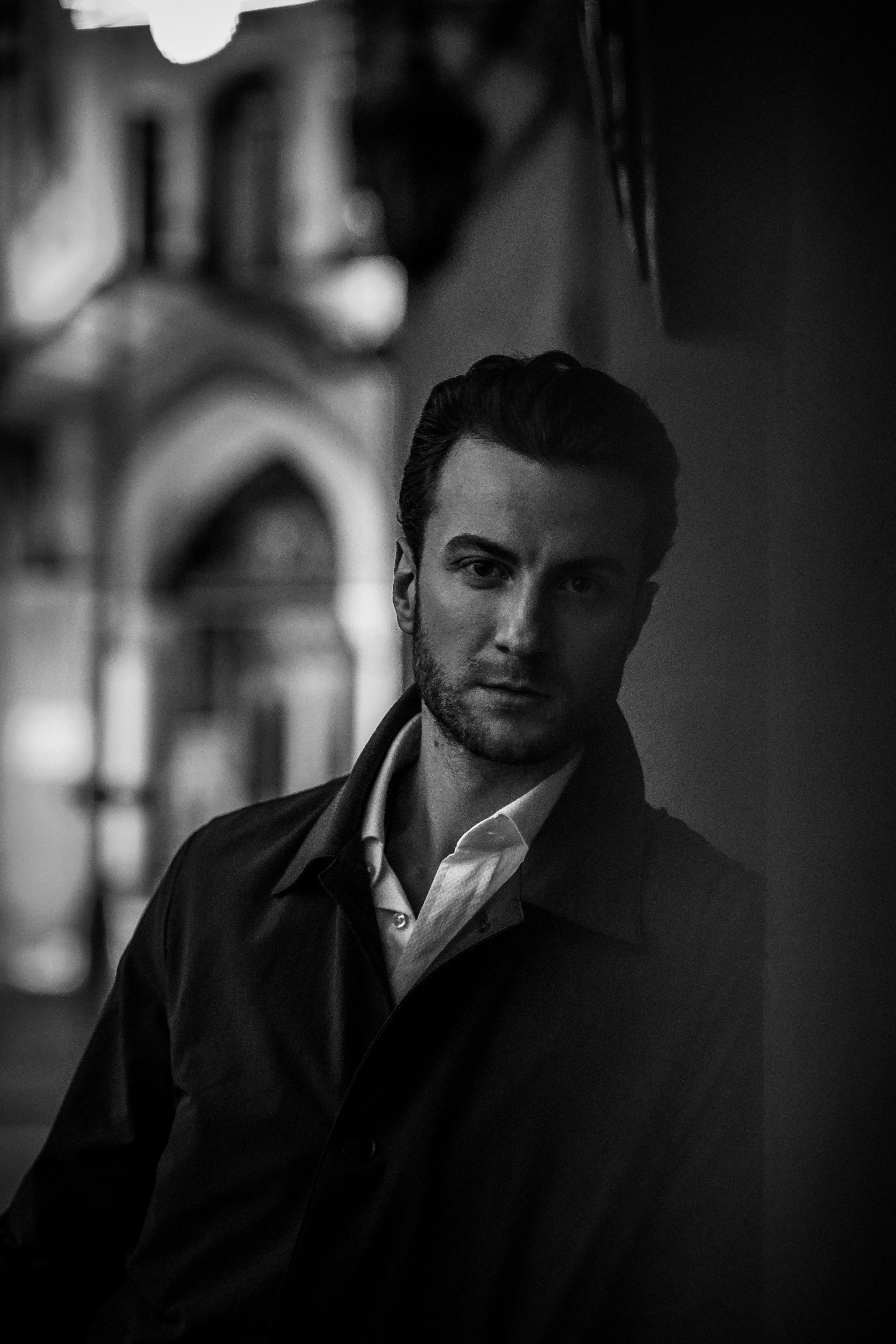 Stylish black and white portrait of a man posing in urban Ankara.