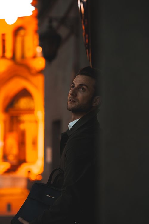 Free A stylish man in a suit poses at night against a vibrant urban backdrop in Ankara, Türkiye. Stock Photo