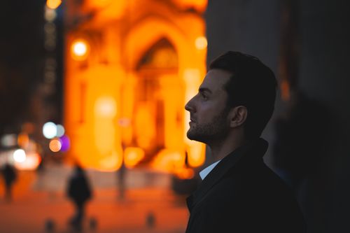 Free Side profile portrait of an adult male in an urban night setting with vibrant lights of Ankara, Türkiye. Stock Photo