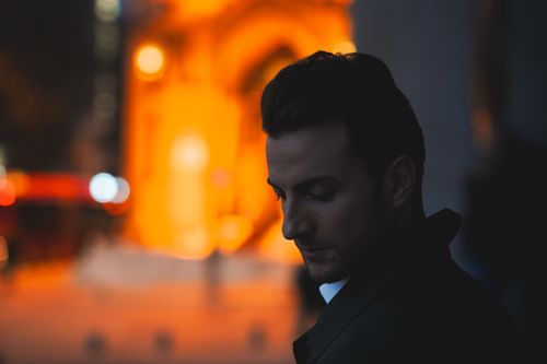 Free A contemplative man captured at sunset against an urban backdrop in Ankara, Türkiye. Stock Photo