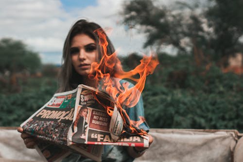 Free Woman Burning Newspaper Stock Photo