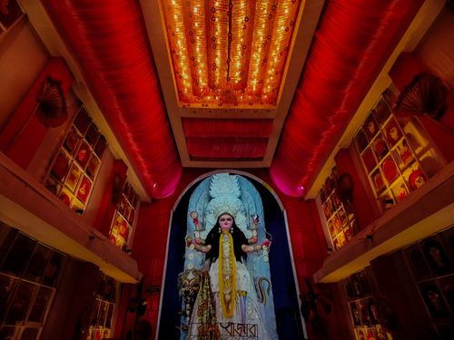 Free Intricately decorated Durga Puja temple interior with vibrant colors and deity statue. Stock Photo